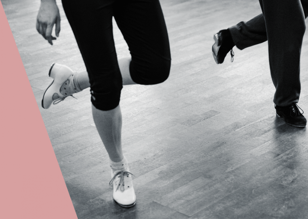 Backstage Studio: Legs and shoes of two tap dancers during class