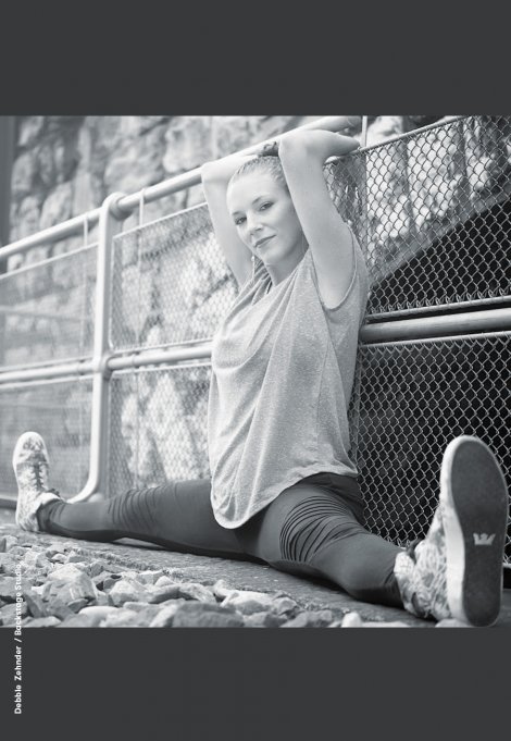 Backstage Studio: Debbie Zehnder Backstage Studio: Debbie Zehnder doing a split, sitting and leaning against a fence